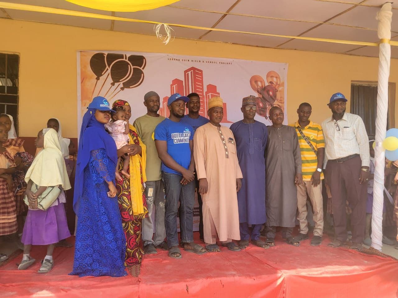Community leaders and supporters standing together at the school opening ceremony.
